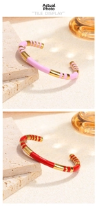 Vertical view of gold-plated enamel bracelets with pink and red stripe patterns