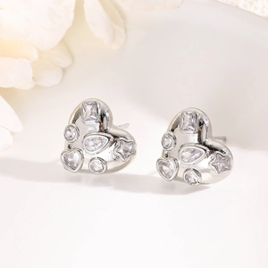 Macro detail of silver heart stud earrings with multi-cut cubic zirconia in a white tray