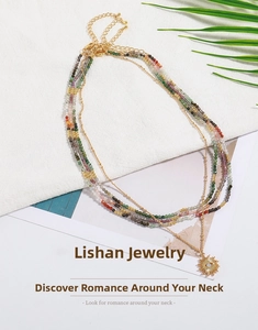 Detail of layered bohemian necklace with colorful beads and a sun pendant in gold finish
