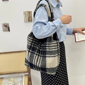 Close-up of checkered plush tote bag showing soft tweed texture and large capacity