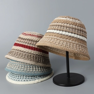Close-up of multicolored striped knitted bucket hats in breathable hollow straw material