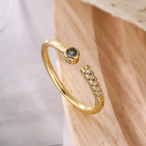 Adjustable gold plated ring featuring dark blue main stone and micro-inlaid white zircons