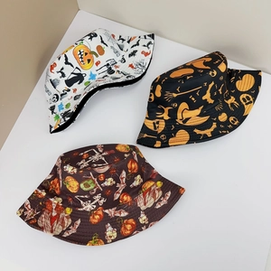 Detailed top view of three reversible Halloween bucket hats with pumpkin and skull prints