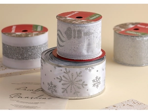 Detail of silver Christmas mesh ribbon with glitter snowflakes and elegant festive patterns