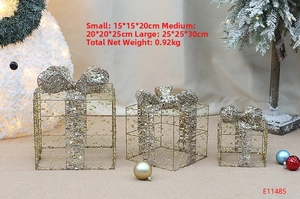 Detailed view of gold wire Christmas gift boxes decorated with white pearls and bows