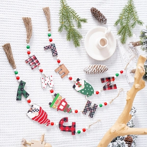 Christmas wooden bead garland with faceless gnome, festive lettering, and jute tassels