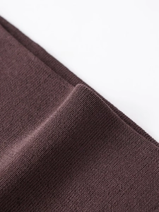 Macro shot of dark coffee brown knitted fabric with fine ribbed texture and soft drape