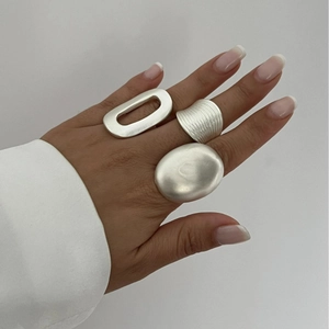 Minimalist silver geometric ring set with brushed finish and oval hollow design