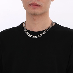 Polished silver titanium steel curb chain necklace worn by a male model on white background