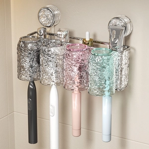 Wall-mounted suction cup toothbrush holder with four colorful ripple cups on bathroom tile