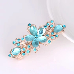 Elegant gold metal hair claw clip with light blue rhinestone flowers and leaf design