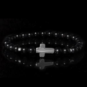 Gothic black matte agate beaded bracelet with silver cross pendant on reflective surface