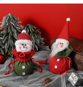 Detail of Christmas knit drawstring bags with Santa and snowman on red background