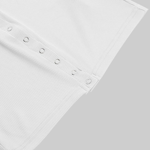Detailed macro view of white ribbed fabric texture and silver snap button closure