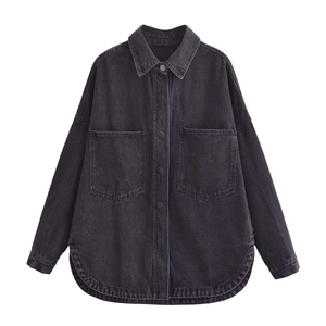 Detailed close-up of dark grey denim shirt jacket with large chest pockets and curved hem