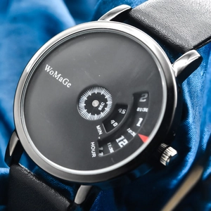Macro detail of rotating disc dial on black watch with silver case and leather strap