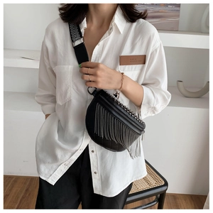 Detail of black PU leather chest bag with silver chain fringe and geometric wide strap