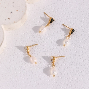 Detailed macro view of 18K gold plated hoop earrings with freshwater pearls and zircon