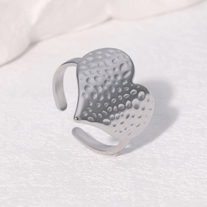 Detailed view of hammered silver heart-shaped adjustable ring with metallic texture