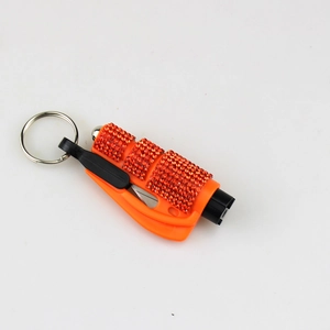 Detail of orange rhinestone car safety tool showing seatbelt cutter and window breaker