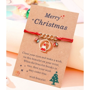 Handmade red woven Christmas wish bracelet with enamel tree charm and festive gift card