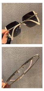 Detail view of large square frame sunglasses with beige temples and grey lenses