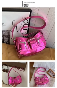 Detail of rose red metallic Y2K shoulder bag with silver rivets and zippers