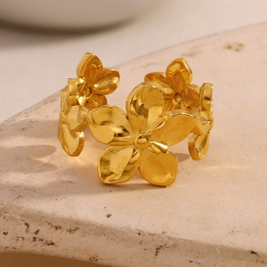 Detail of 18K gold plated flower ring showing hammered texture on flower petals