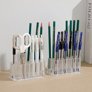 Clear acrylic 26-hole organizer stand for makeup brushes and stationery pens on a wooden desk
