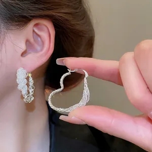Silver openwork heart hoop earrings with twisted texture and pave cubic zirconia