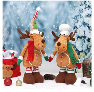Detail of Christmas reindeer plush toys with knit textures and festive scarves in snow scene