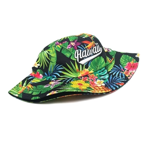 Close-up of tropical floral print and white Hawaii embroidery on a black bucket hat