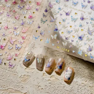 Macro view of M-1068 3D butterfly nail stickers with gold stamping on nude manicured tips