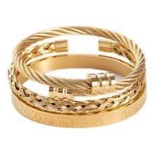 Three-piece gold bangle set featuring twisted cable, woven texture, and Roman numeral motifs