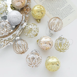 Golden and silver 6cm Christmas ball ornaments with glitter and mesh on a vintage mirror