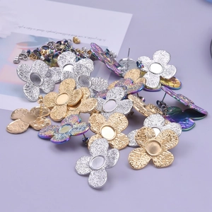 Detail of four-petal flower stainless steel earring bases in silver, gold, and rainbow colors