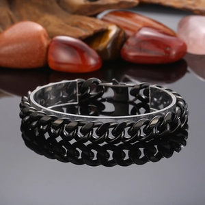 Close-up of black Cuban chain bracelet on a stand with agate stone and wood accents