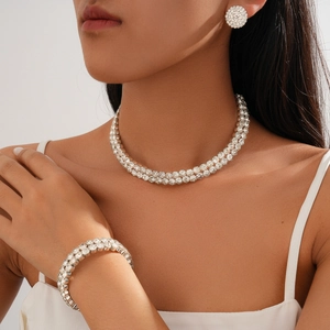 Three-piece luxury silver layered necklace with pavé diamond geometric earrings and bracelet set