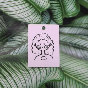 Pink earring display card featuring a minimalist doodle character and hanging hole