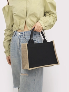 Detail of the black canvas tote bag with jute trim and comfortable top handles