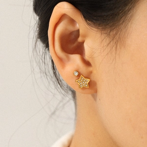 Star and round zircon stud earrings set in gold stainless steel worn by a model