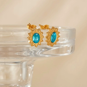 Vintage sunburst gold stud earrings with oval blue zircon inlay in a geometric design
