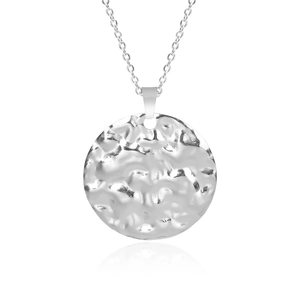 Macro shot of a hammered texture silver circular pendant on a stainless steel chain