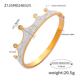 Detailed view of crown shaped titanium steel bracelet with 18K gold plating and diamonds