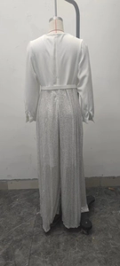 Back view of elegant white long sleeve top with silver sequined wide leg trousers