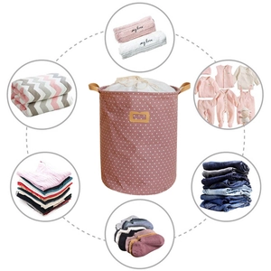 Pink polka dot cotton linen laundry basket with drawstring closure and carry handles