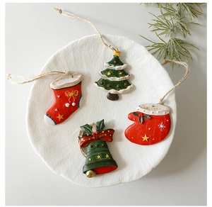 Detailed set of four mini resin Christmas tree ornaments in festive red and green tones
