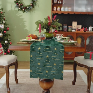 Green velvet Christmas table runner with gold embroidered stars on a wooden dining table