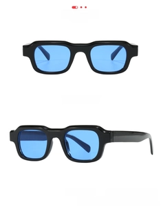 Detail view of retro rectangle black frames with dark blue lenses and thick temples