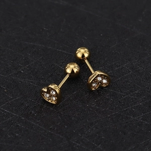 Close-up of gold heart stud earrings with white zircon and secure screw ball backing